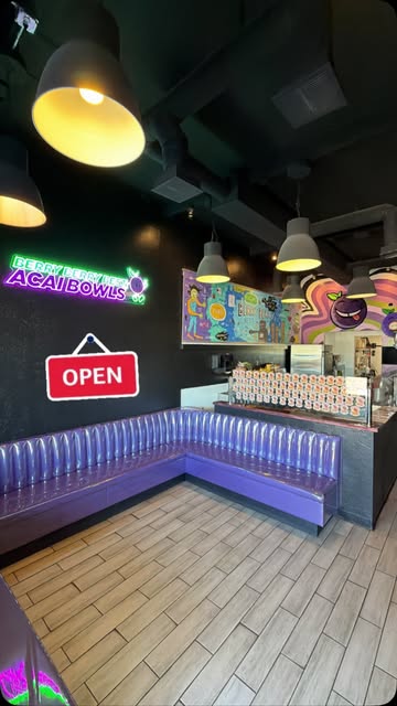 Neon sign and purple booth inside the shop